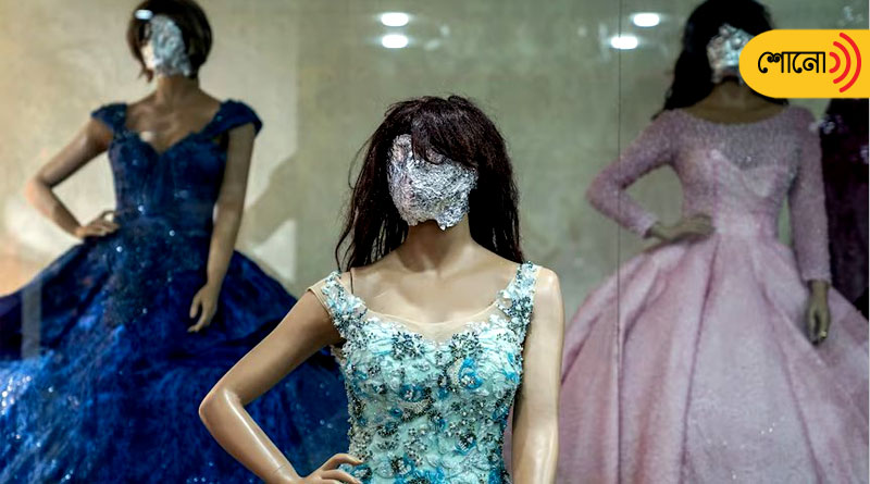 shopkeepers cover female mannequins' faces under Taliban rules